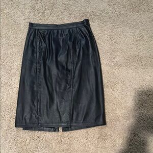 Fully lined black leather skirt.